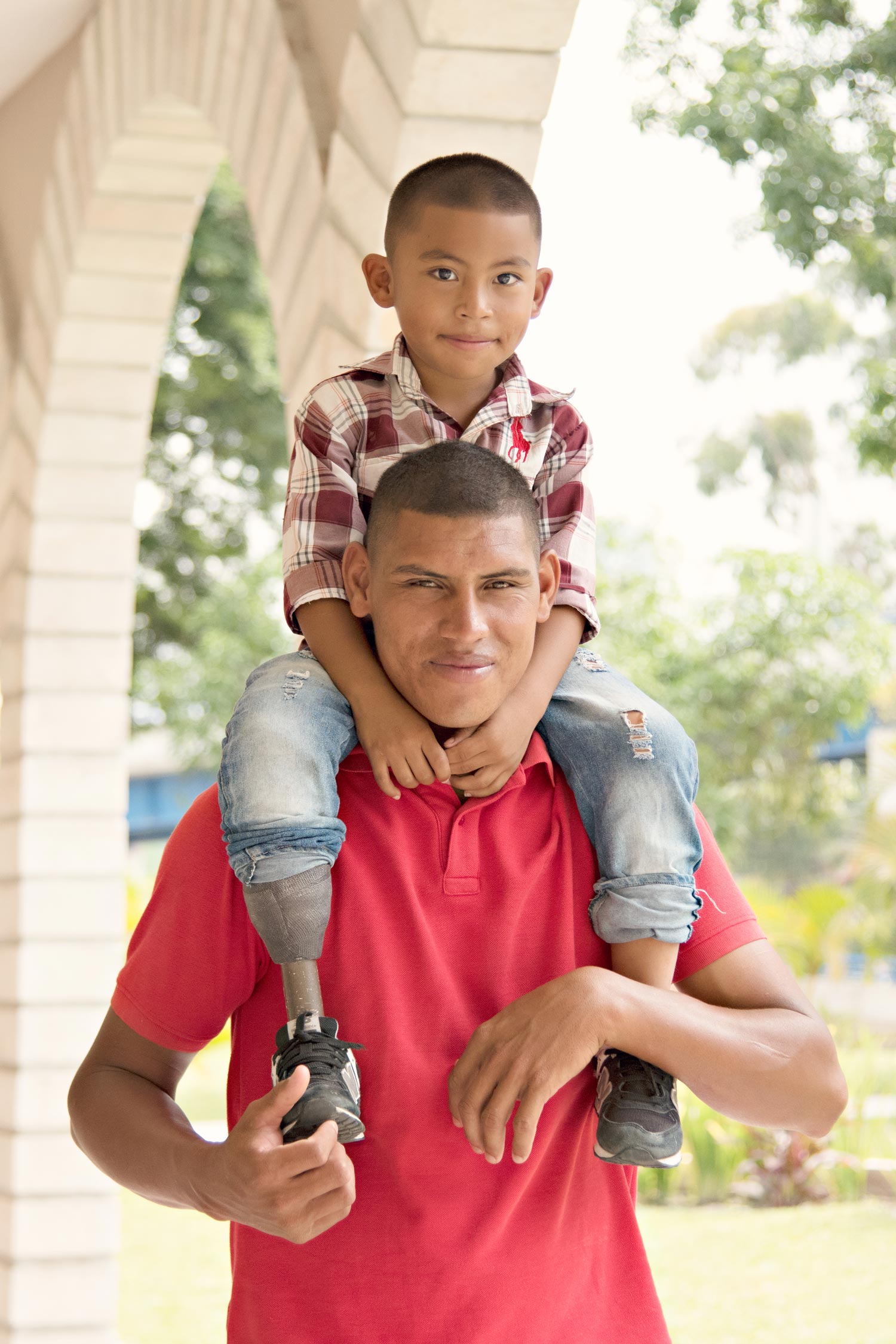 image of a boy sitting on his father's shoulders