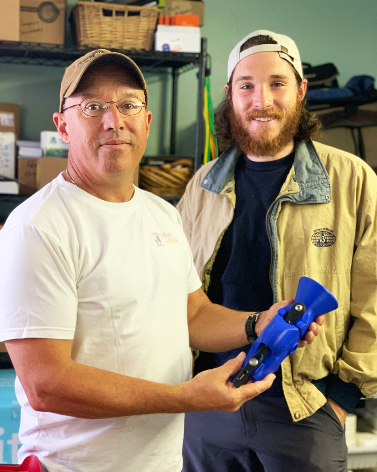 image of two men holding a prosthetic knee