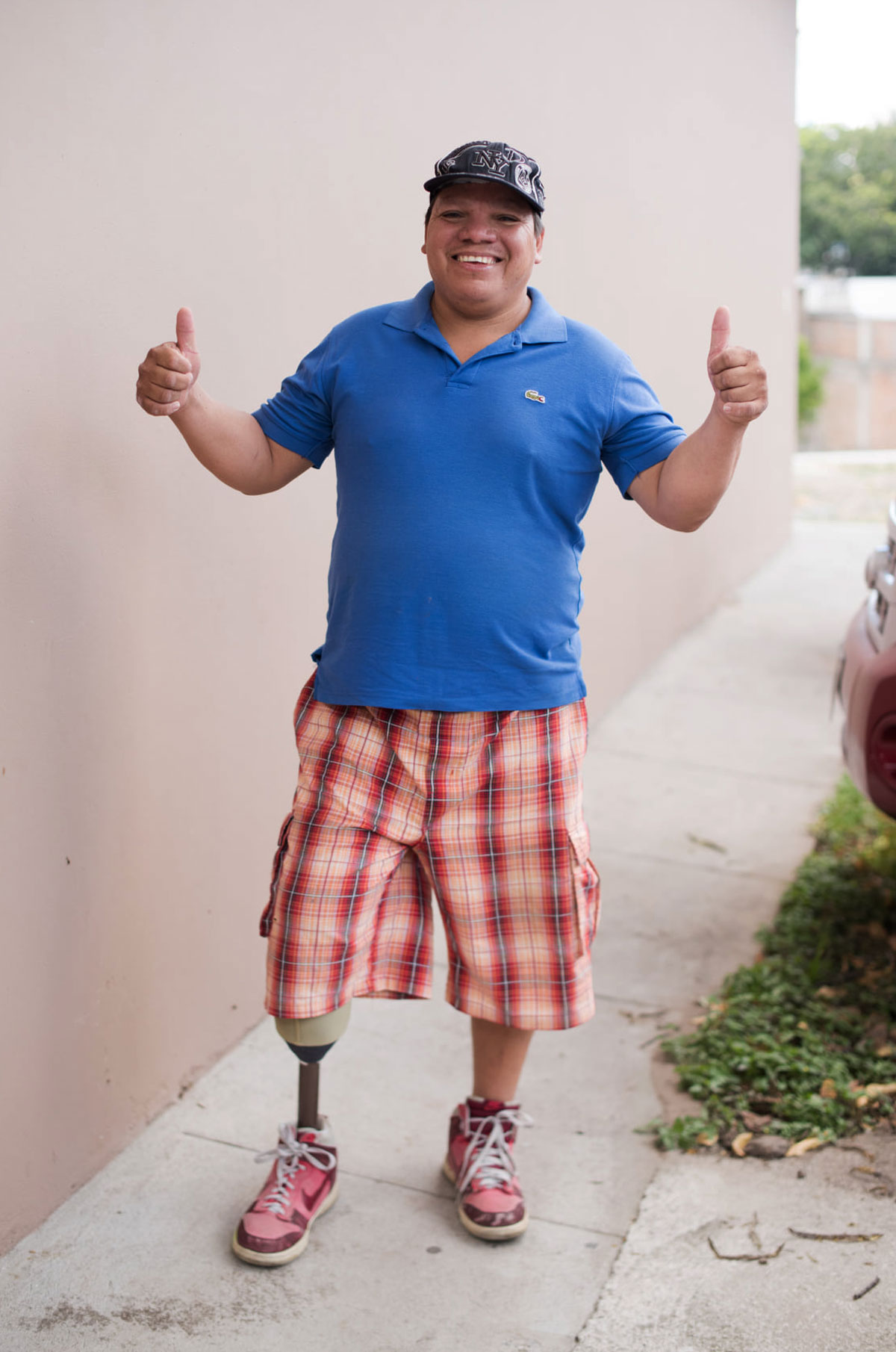 image of a man standing giving the thumbs up sign